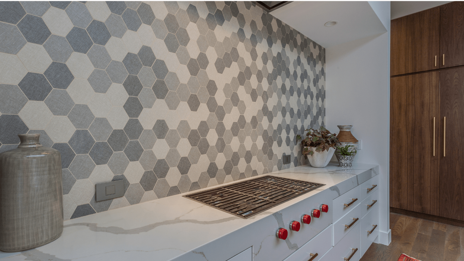 Kitchen counter with a hexagonal backsplash of various grey colors.